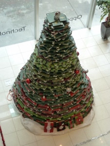 Top view of tall green Christmas tree constructed from books.