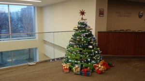 Tall green Christmas tree constructed of books.