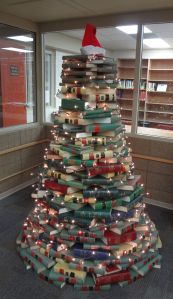 Tall colorful Christmas tree constructed from books.
